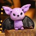 Macro shot of a purple plush bat toy with black PU leather wings and a white star - Purple Devil Bat