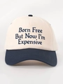 Close-up of Born Free embroidery on cream and navy blue cotton twill baseball cap - Cream/Navy Blue