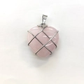 Pink crystal heart pendant wrapped in silver wire mesh on a clean white background - Rose Quartz