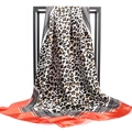 Detail of satin leopard print scarf featuring red borders and geometric wave patterns - 90x90cm / Coral Red Leopard