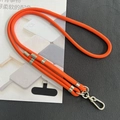 Close-up of thick orange braided phone lanyard with silver metal ring and lobster clasp - 8mm Dual Adjustable / Orange Red