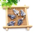 Five angel-shaped natural sodalite stone pendants with silver metal clasps on a tray - Sodalite