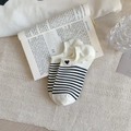 Women's low-cut boat socks featuring black and white stripes with a small heart patch - White