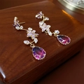 Close-up of golden flower earrings with purple gradient crystal waterdrop pendants - Silver Pin - Purple Flower Drop Earrings