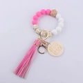 Detail of pink silicone beads, wood Mama tag, and tassel on a handmade wristlet keychain - Rose Red