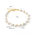 Macro detail of 18K gold plated stainless steel bracelet with white pearls and beads - Gold Round Beads with Irregular Pearl Bracelet