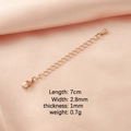 Macro detail of rose gold extender chain with lobster clasp on pink silk background - Rose Gold