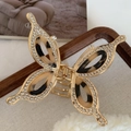 Macro view of gold alloy butterfly hair claw with rhinestones and tortoiseshell resin wings - Light Tortoiseshell