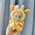 Labubu doll in a plush yellow rabbit outfit with colorful bows and blue accents - Yellowcake Three-piece Set / First And Second Generation Keychains Are Compatible With La Cloth Dolls. Dolls Not Included.