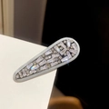 Close-up of elegant zircon arrow hair clip with sparkling crystals on white surface - Water Drop Long Oval Style