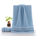 Light blue soft cotton face towel with navy blue stripes shown in a hanging display - Gradient Stripe Blue / 34*74cm