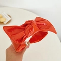 Detailed close-up showing the orange faux leather texture of the bow headband - Leather Bow Headband / Orange