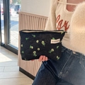 Black textured makeup bag with green floral embroidery and top zipper closure - Dark Floral Green