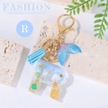 Ocean beach style letter R keychain with sand, shells, and blue tassel charm - Letter R