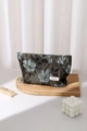 Macro detail of vintage floral jacquard cosmetic bag with H & R BAG label on wooden tray - Golden Thread Flower Large