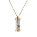 Detailed macro of a gold cylinder pendant necklace filled with white natural stones - Gold White Pine