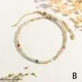 Macro shot of 2-3mm colorful natural stone beads with golden clasp and extender chain - Amazonite