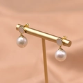 Elegant 925 silver earrings with natural freshwater pearls on a gold display stand - White Pearl Pendant Style