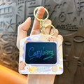 Cute Capybara TV-shaped keychain with a rotating face feature for backpack decoration - Writing Board - Purple