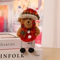 Detailed close-up of a Christmas plush bear ornament with tartan hat and beaded legs - F2-3 Hanging Black Leg Bear