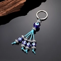 Ethnic blue evil eye keychain with silver metal rings and braided tassel pendant - 4 Strings Eye Beads