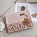 Pink cashmere feel scarf with fringe and leather logo tag on fabric background - 38# Marl Pink