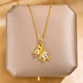 Macro detail of golden teddy bear pendant with large water-drop zircon on silk jewelry box - Gold Teddy Bear