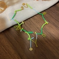 Detail of beaded flower necklace with green seed beads and gold lobster clasp closure - Light Green/Handmade Small Flowers