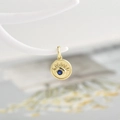 Golden evil eye pendant with blue zircon center and radiant sunburst metal pattern - Dark Blue Zirconia