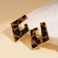 Detail of leopard print flocking heart earrings with gold trim on marble - Leopard Rhombus Stud Earrings