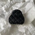 Detail of a black quilted matte claw clip with diamond pattern stitching on white paper - Small / Black