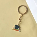 Golden graduation keychain featuring a black mortarboard hat and colorful books charm - Style 5 (Flat Ring)