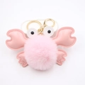 Detailed view of pink plush crab keychain with gold metal clasp and soft faux leather claws - Light Pink