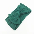 Detail of forest green cable knit baby headband with a large decorative bow - Dark Green