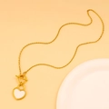 Macro detail of gold-plated OT toggle clasp and white heart pendant necklace - White Enamel Heart Necklace (CK1369)