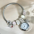 Detail of silver beaded bracelet watch with pink floral and rhinestone crown charms - Silver Transparent Bead Bangle
