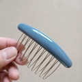 Hand holding a blue minimalist hair comb clip with silver metal wire teeth detail - Light Blue