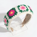 Detail of handmade crochet flower headband with colorful embroidery on white knit - Green Pink White