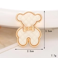 Detailed view of an ivory bear charm for clog shoes with gold trim and bow, size 3.5x2.5cm - C472 Bowknot Bear White