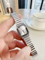 Close-up of elegant square silver steel watch with minimalist dial on a female wrist - White Dial / Silver