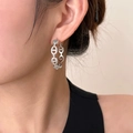 Silver link hoop earrings with pavé cubic zirconia worn by model on beige background - Pig Nose Full Zirconia Design (232) / Silver