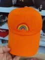 Detailed view of vibrant rainbow embroidery on orange cotton fabric of a baseball cap - Orange