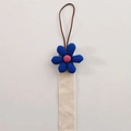 Beige woven hair clip holder with a blue flower charm and a brown hanging cord - Blue Large Flower