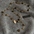 Detail of tiger eye bead necklace with a gold leaf pendant on grey velvet background - Full Rhinestone Leaf Pendant Style / Gold Brown