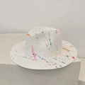 Artistic detail of a white straw panama hat featuring vibrant colorful paint splatter design - M / White (Graffiti Splatter)