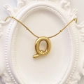 Golden balloon style letter Q pendant necklace with puffy texture in a white frame - Gold Letter Q