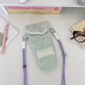 Detailed close-up of blue and yellow quilted plaid camera bag with pink heart button - Green-Yellow Checkered