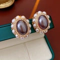 Close-up of vintage court style zircon earrings with pearls on dark green jewelry box - Silver Pin - Grey Purple - White