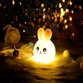 Cute bunny shaped LED night light with warm yellow glow on a soft white fur base - Large-eared Rabbit