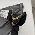 Chic black hobo shoulder bag with fashion label and gold chain on gray blazer - Black